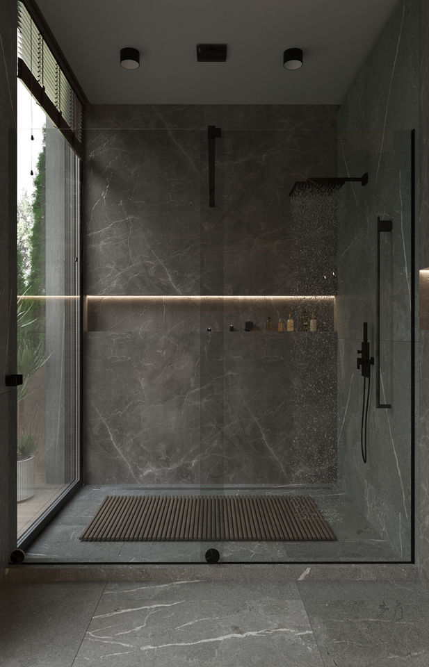 Modern bathroom with glass shower, light, and marble wall with a mat.