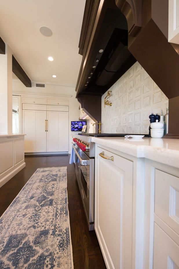White shaker kitchen cabinets with custom hardware and storage solutions
