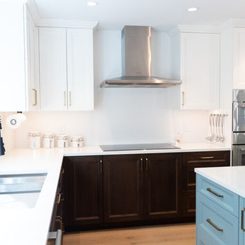 Custom kitchen design featuring white cabinets, quartz surfaces, and stainless steel appliances