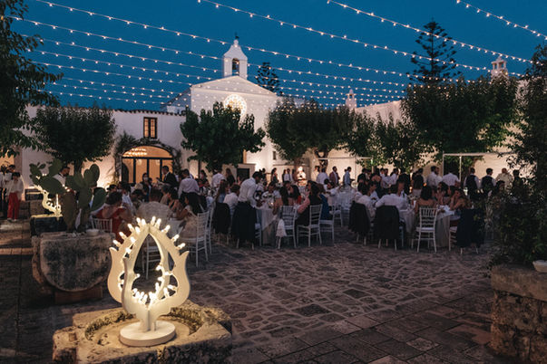 Outdoor wedding reception at the historic courtyard of Masseria Montalbano in Ostuni.
