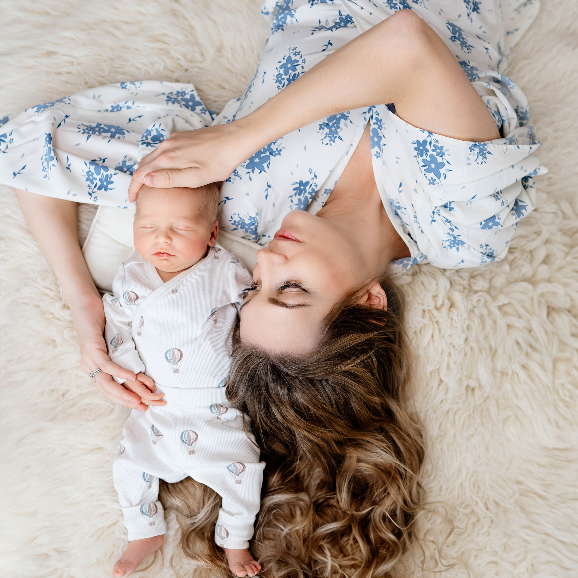 Mother and newborn baby sleeping peacefully together