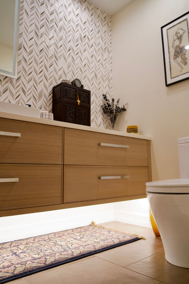 Modern bathroom remodel featuring floating vanity, custom storage, and decorative wall tile