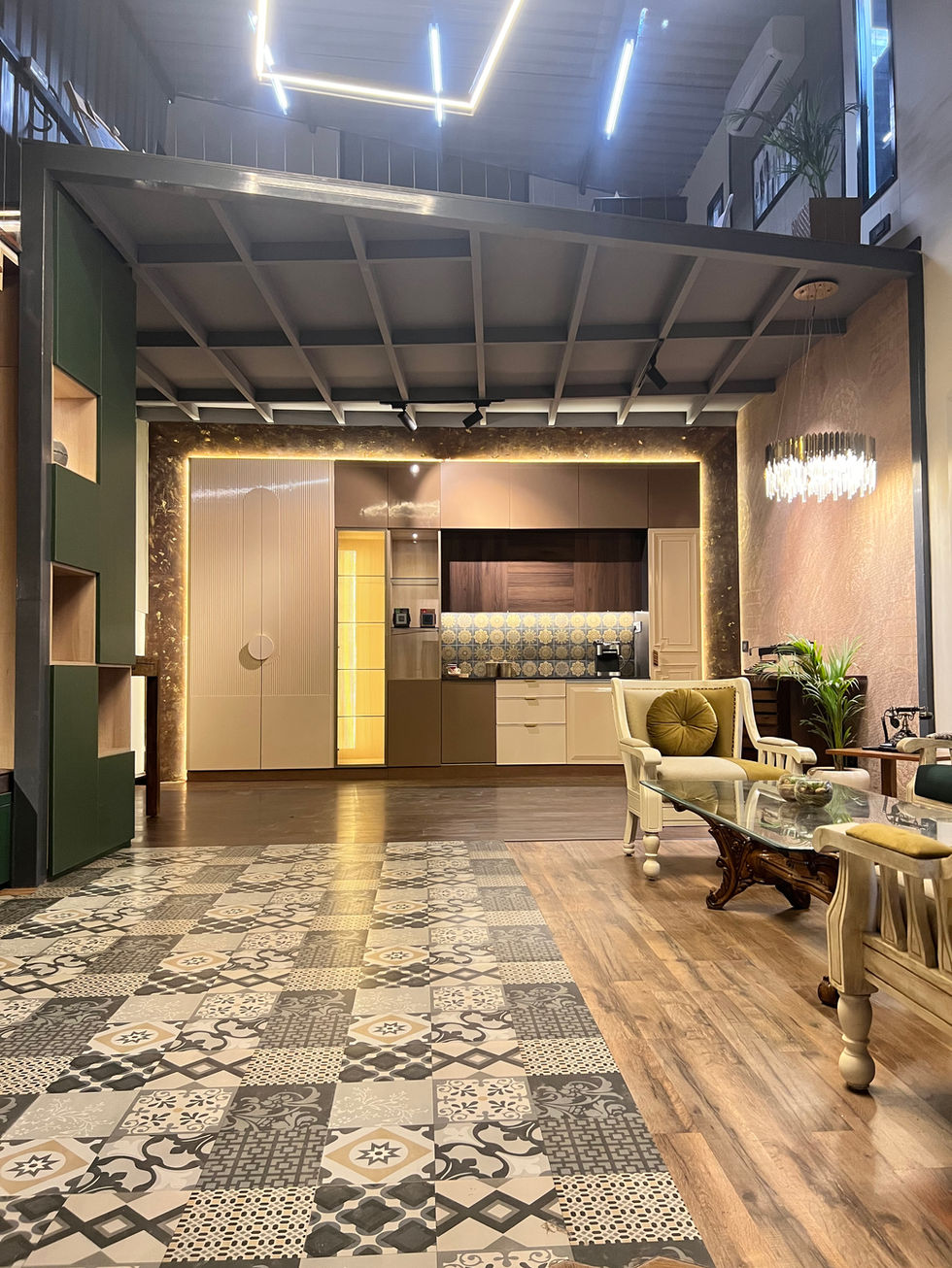 Living room interior featuring a gallery wall with black and white framed artwork. Mid-century modern sofa with geometric patterned rug in the foreground. Upscale design with curated artwork and statement lighting.