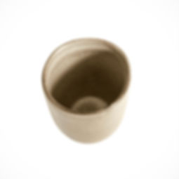 Top view of handcrafted ceramic tumbler showing curved shape and neutral-toned glaze.