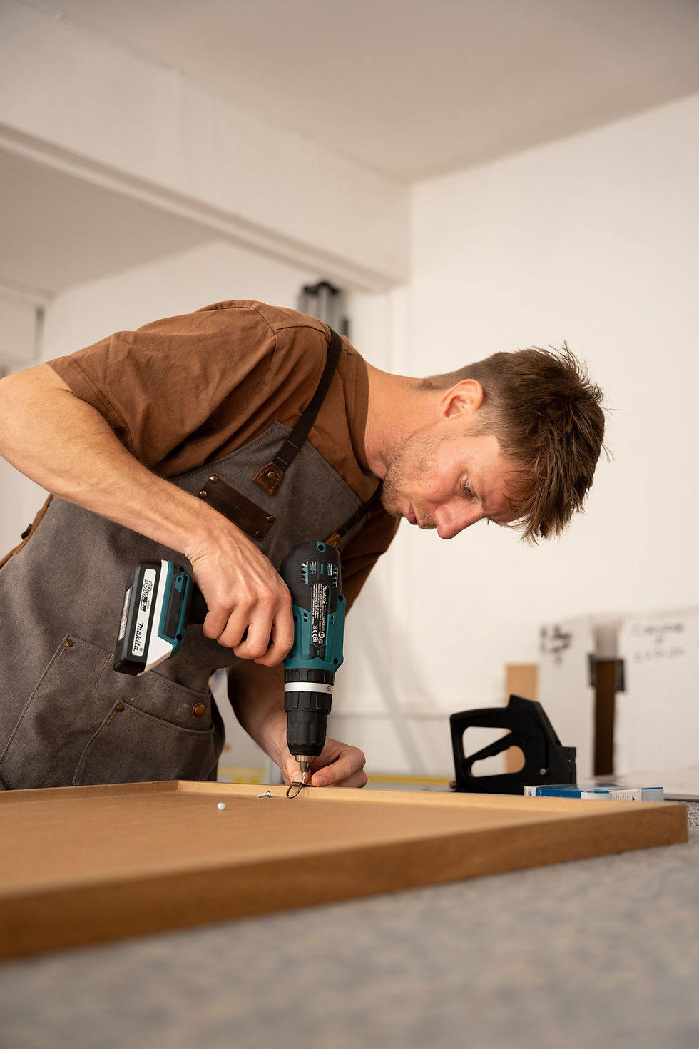 Close-up of bespoke picture frame being handcrafted and painted in workshop, filmed for Capstone Framing content campaign