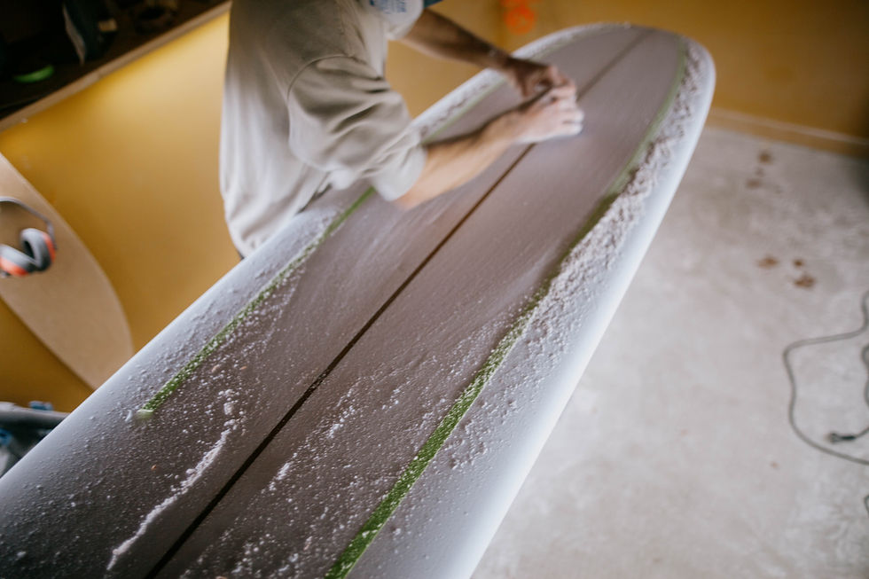 ANtonio Mello from hamanda shapes shaping a longboard concave