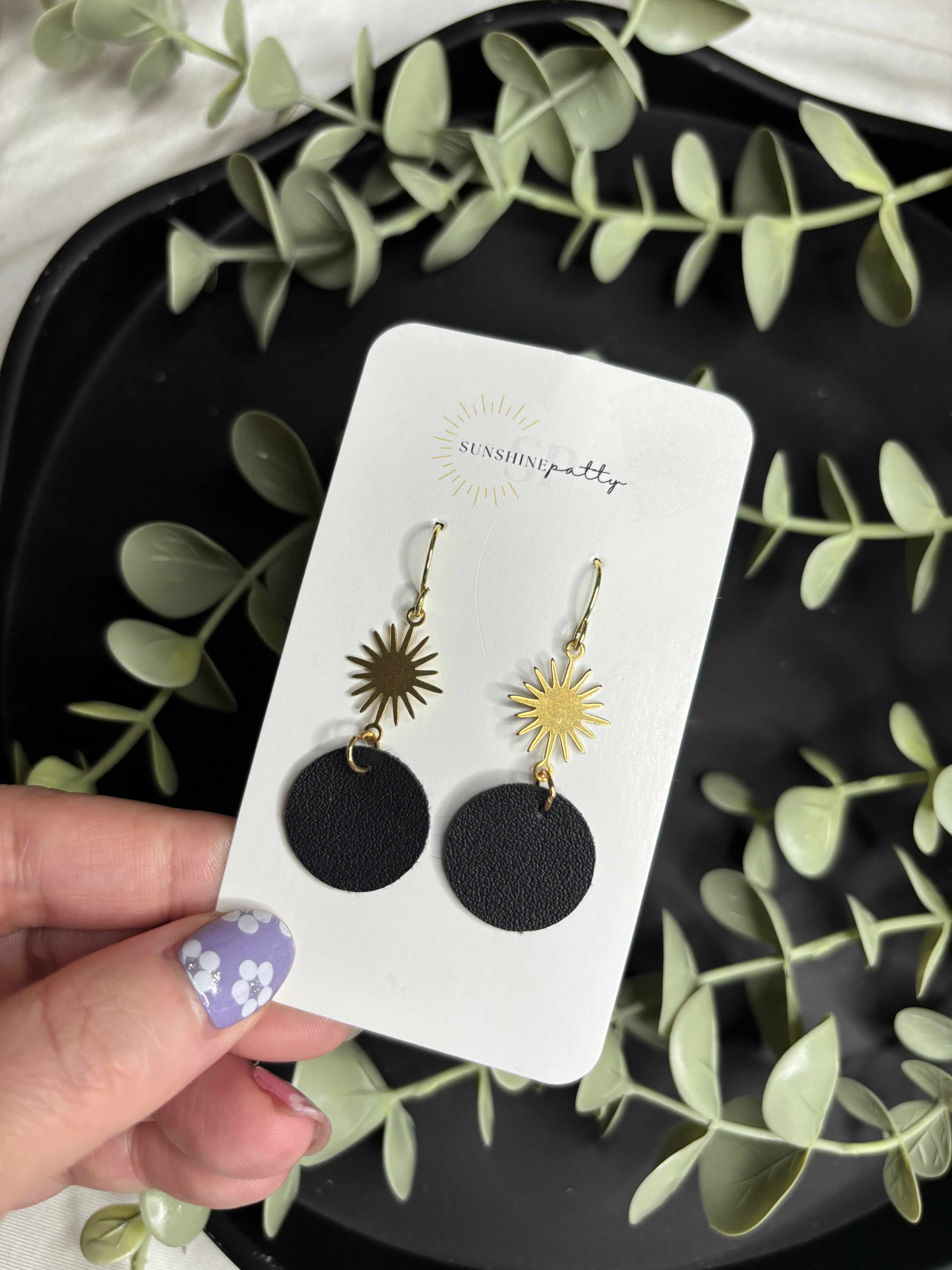 Black Circle with Sunburst Charm