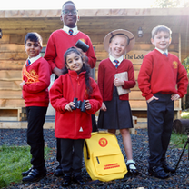 Welcome to Hill Avenue Academy: students and teacher with learning equipment