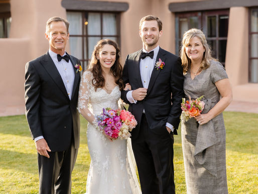 Bride and groom with groom's parents wedding portrait