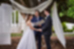 Bride and groom at ceremony with officient.