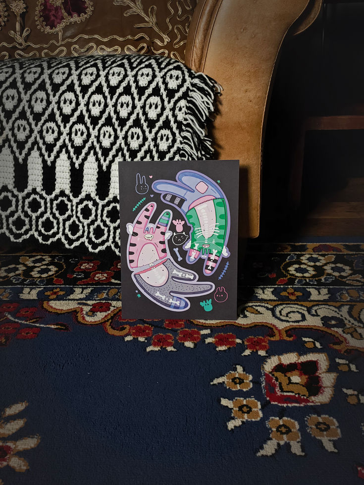 portrait view black art print features two large, stylised "pastel goth" cats floating in a circular, yin-yang-like formation