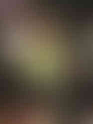 back view of mini black sacred heart sculpture. rustic and colourful flat surface with metal hook for hanging.