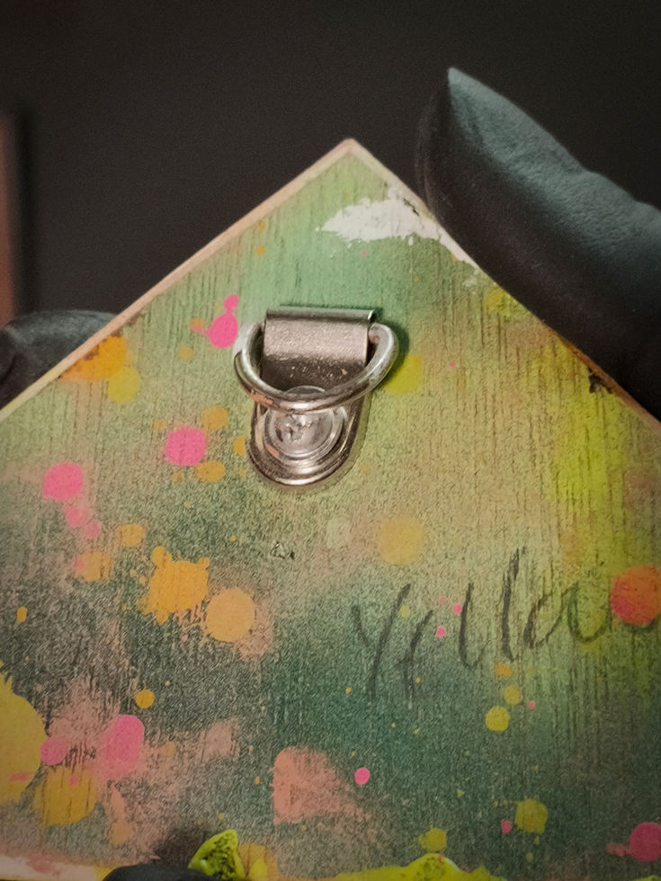 close up of metal hook for hanging on the back of triangle vision sculpture