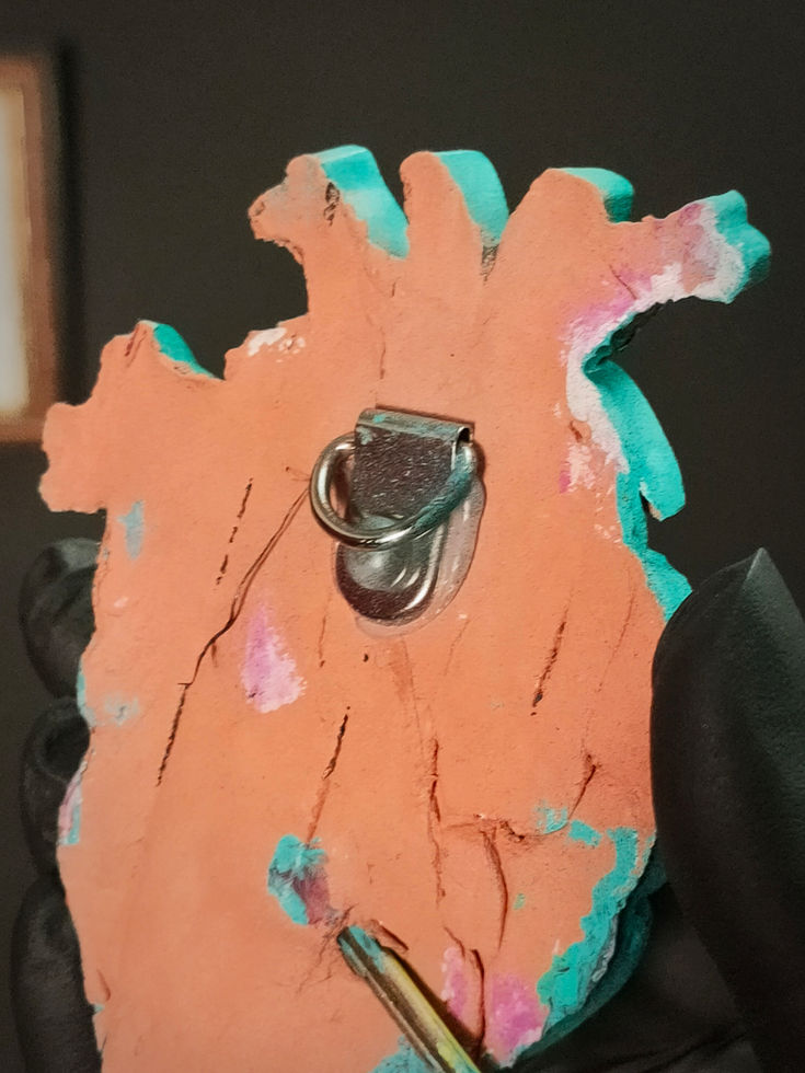 close up of metal hook for hanging on the back of anatomical heart sculpture