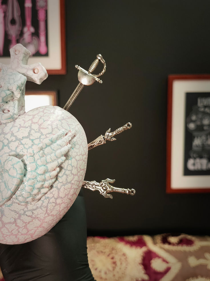 close up front right view of white crackle glazed mini sacred heart sculpture