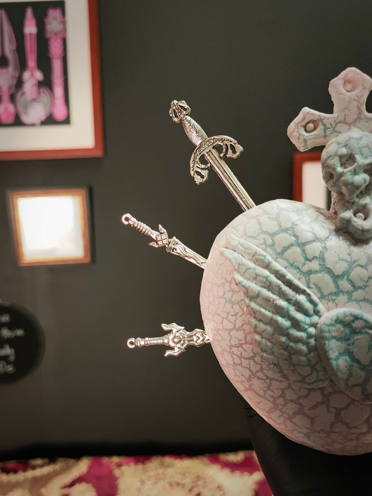 close up front left view of white crackle glazed mini sacred heart sculpture