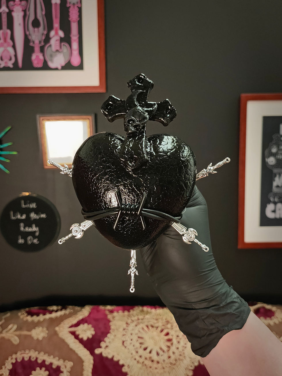 Front view of mini black sacred heart sculpture