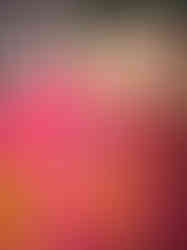 close up of metal hook for hanging on the back of vibrant green sacred heart sculpture with orange and yellow conical spikes.