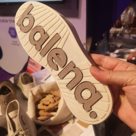 a hand holding plastic alternative sneaker sole