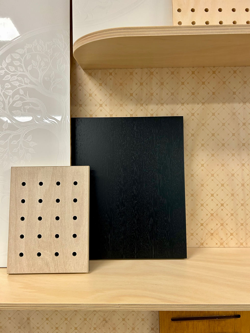 Architectural panel samples displayed side by side in the ARTIEM showroom to compare pattern, texture, finish and scale.