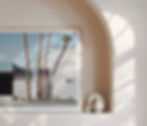 Framed art of palm trees in arched alcove