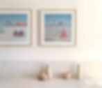 Framed art prints featuring palm trees, buildings, and a pool scene
