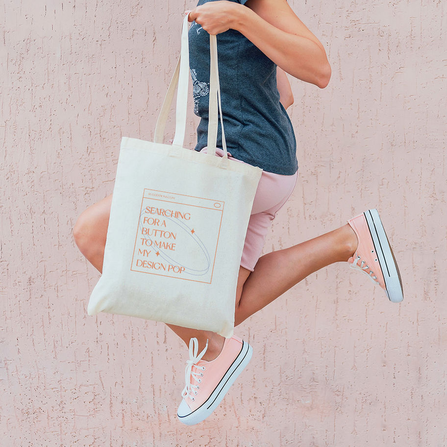 Person jumping with a tote bag that says,