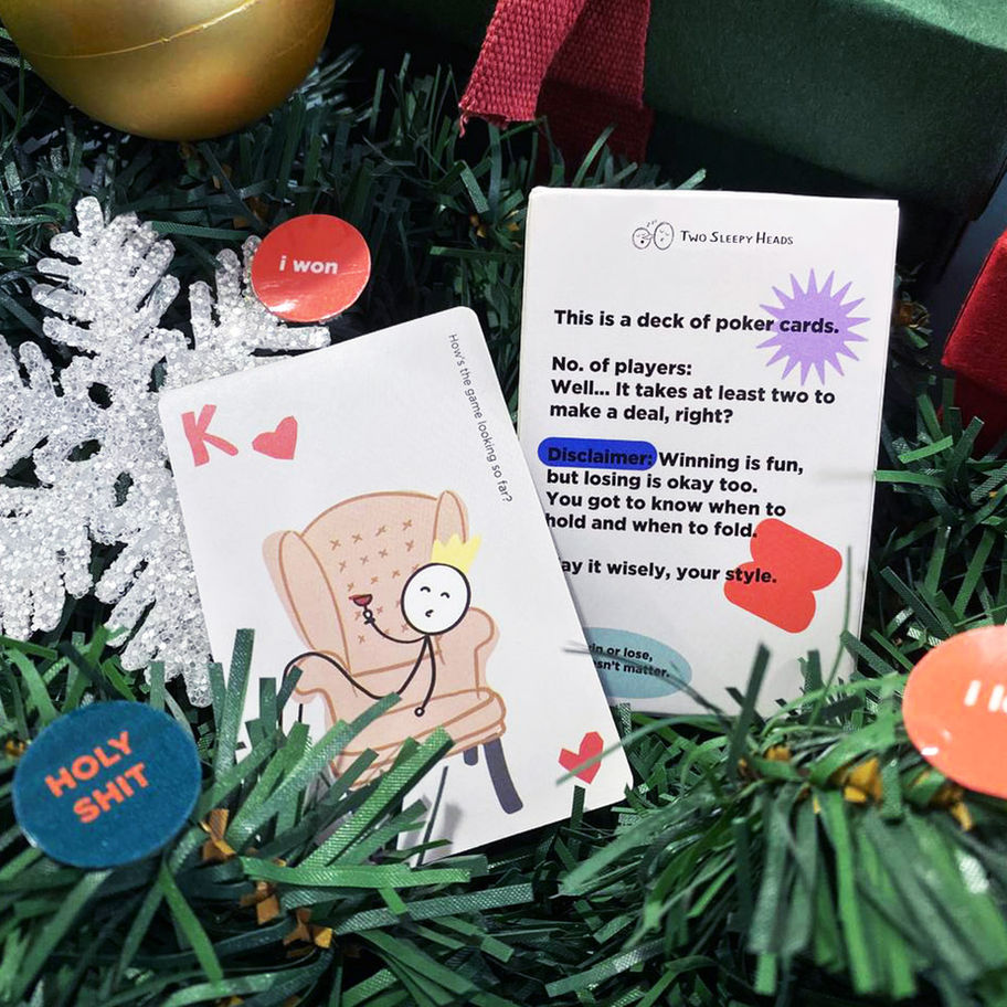 King card in focus, with text, next to cards on a Christmas tree. Fun Game Studio.