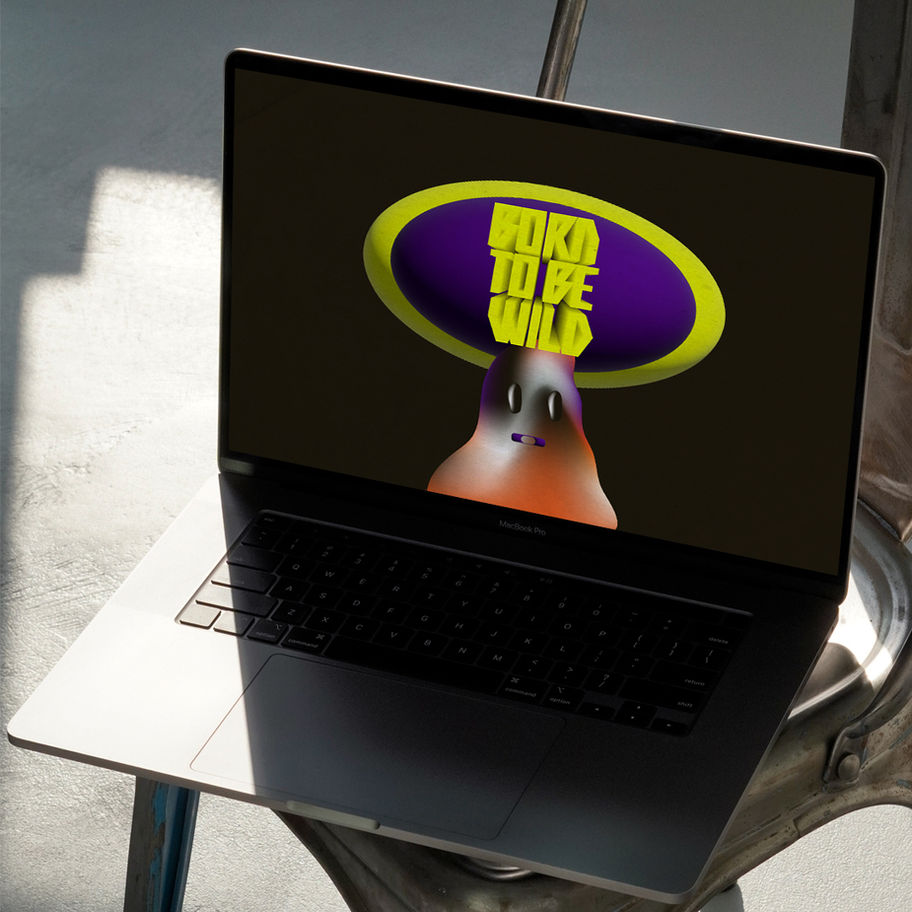 Laptop displaying "Born to Be Wild" logo on a table with sunlight shining.