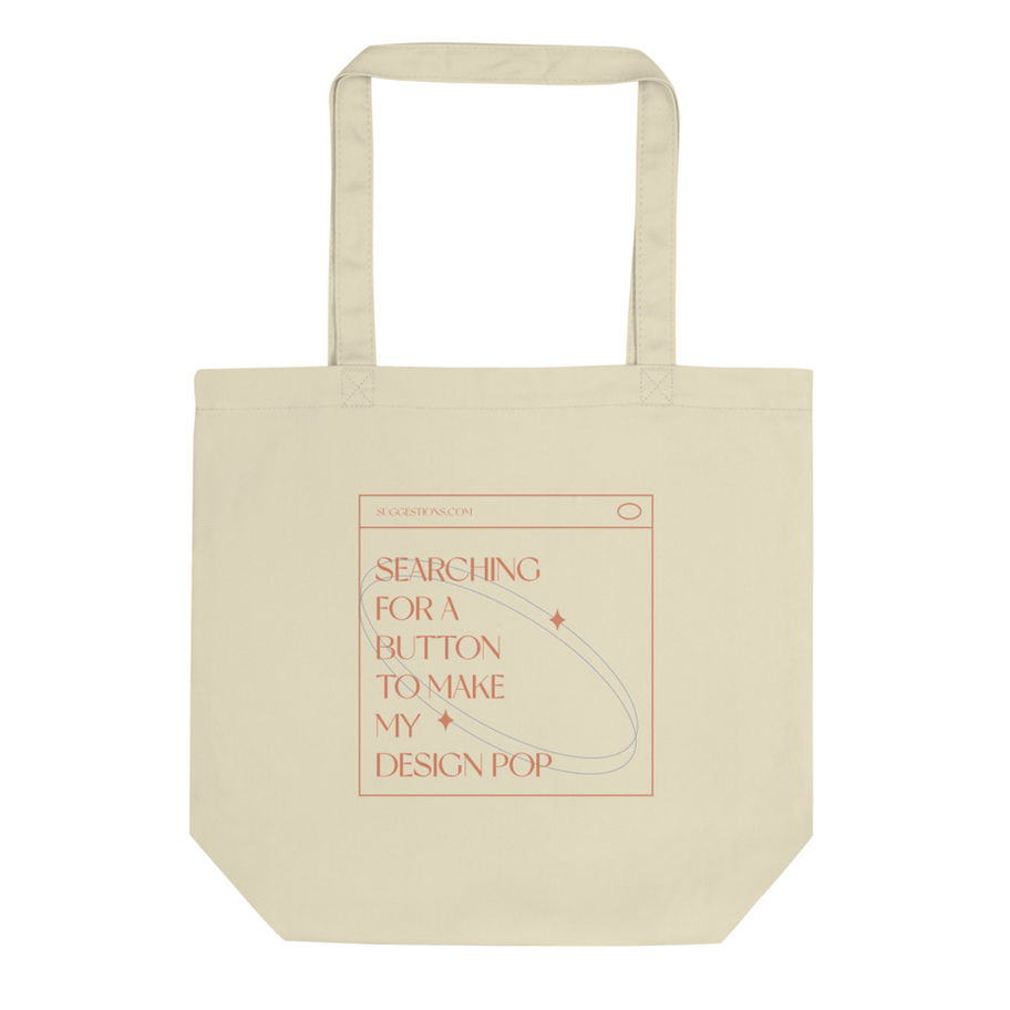 Cream tote bag with text: Searching for a button to make my design pop.