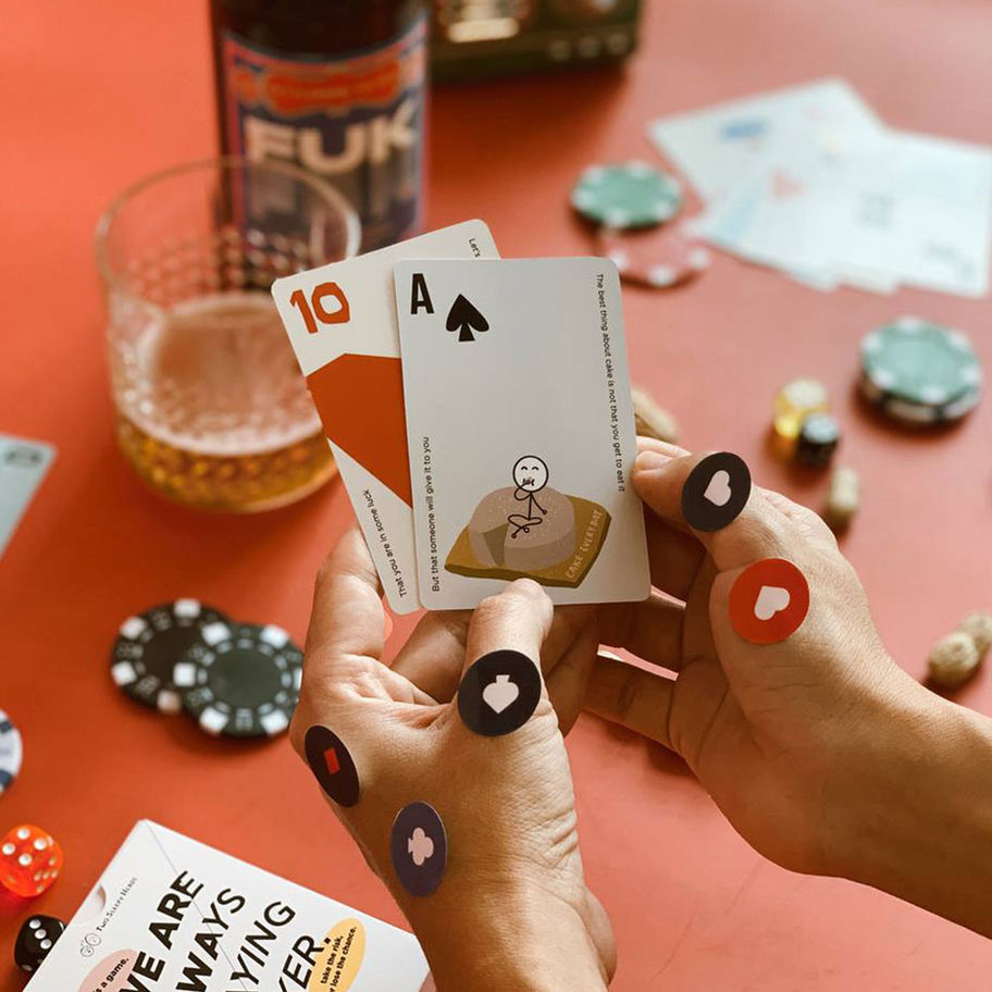 Hands holding Ace and Ten cards with poker chips on a table setting, Brand Refresh