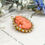 Thumbnail: Antique Carved Coral Brooch with Pearl Halo in Gold