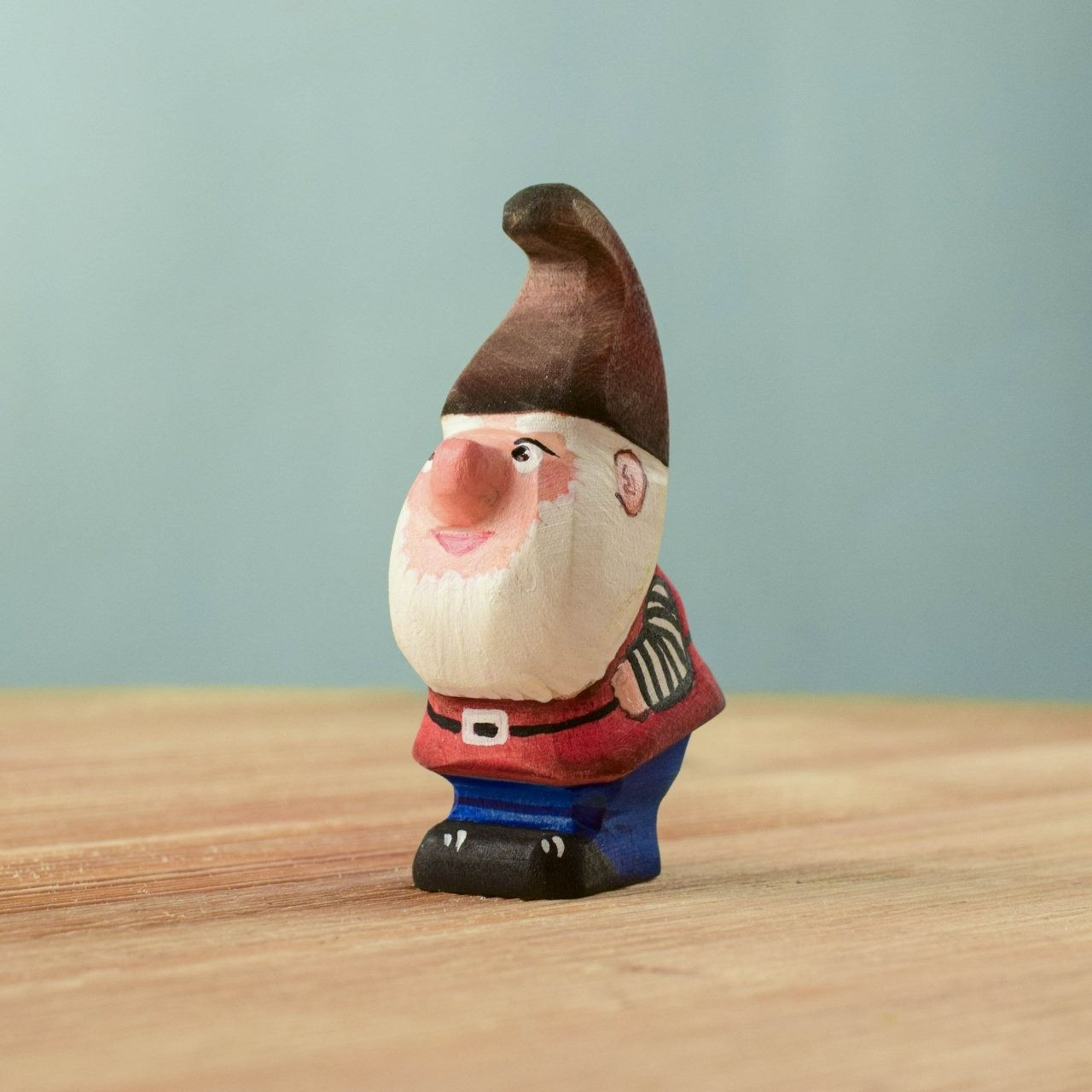 Bumbu Toys Wooden Whittle Dwarf Figurine on a wooden surface