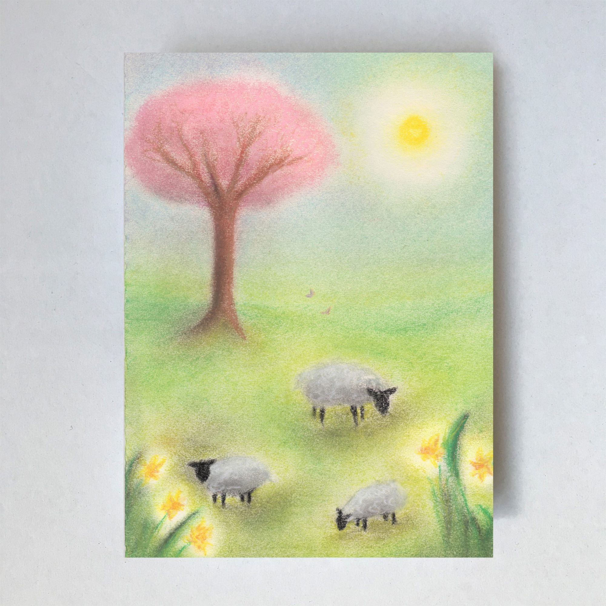 An A6 postcard by Lot Bouwes featuring illustration of sheep grazing in a green spring meadow with daffodils & a pink tree.