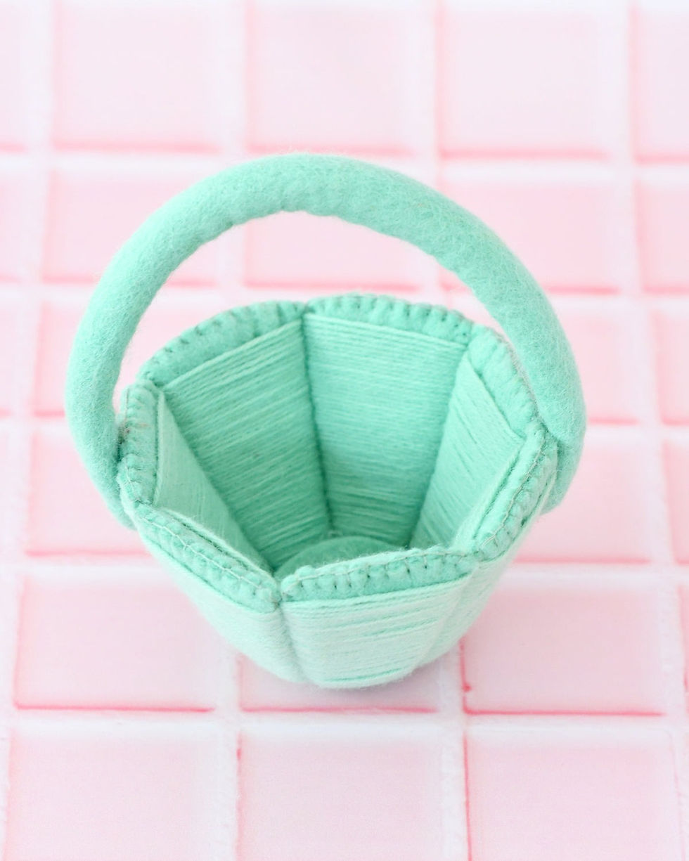 Thumbnail: Interior view of petite teal felt Easter basket showing soft wool lining