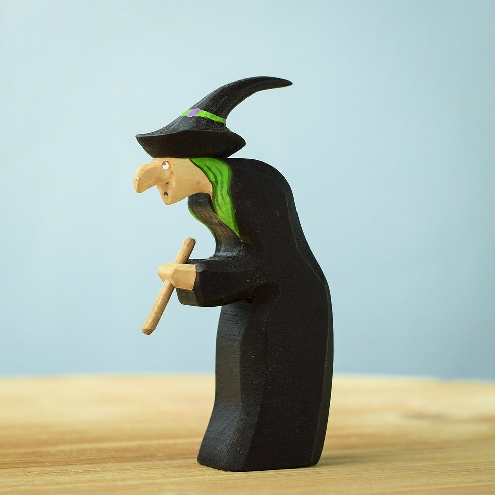 Bumbu Toys Handcrafted wooden brewing witch figurine standing upright.