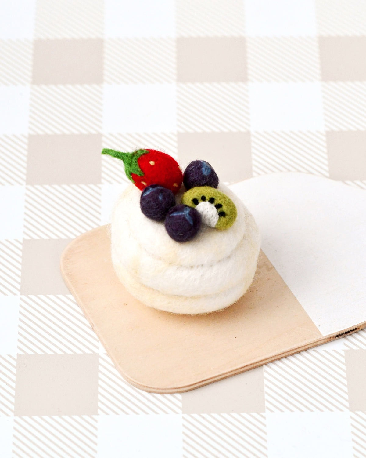 Tara Treasures Felt Pavlova Meringue Dessert on a wooden cutting board