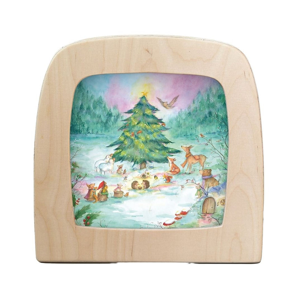 Toverlux Yuletree Grove silhouette illuminated in a frame showing woodland animals gathered round a Christmas tree.