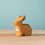 Thumbnail: Bumbu Toys Sitting Wooden Rabbit  on a wooden surface