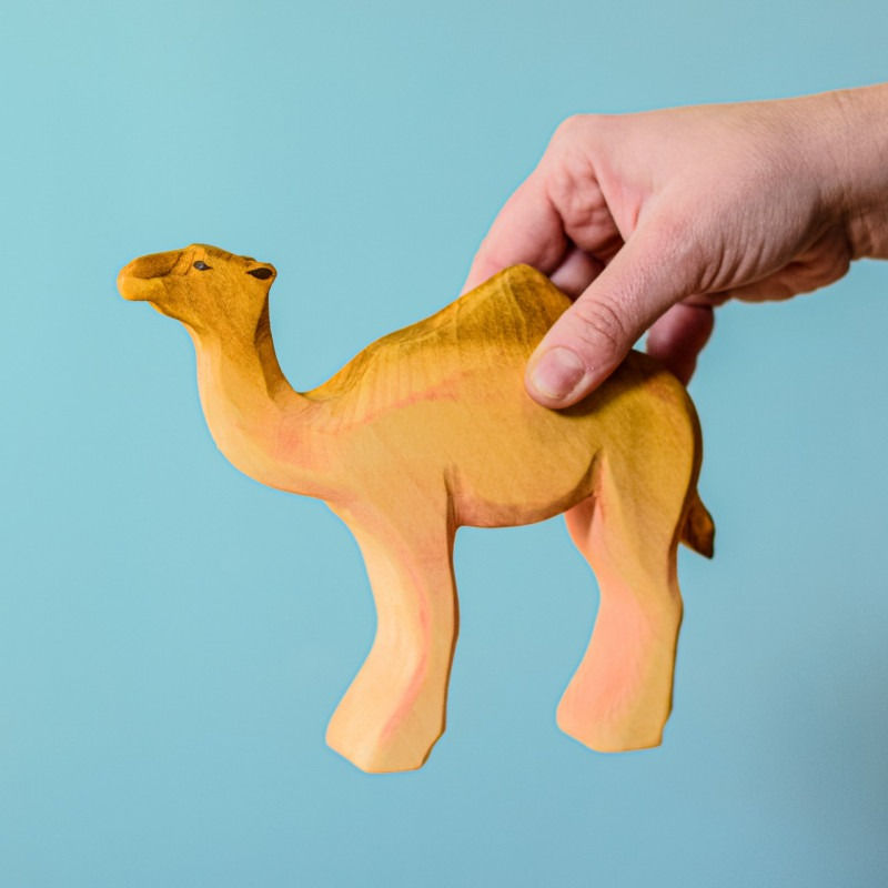 Thumbnail: Hand Holding the Wooden Camel by Bumbu Toys
