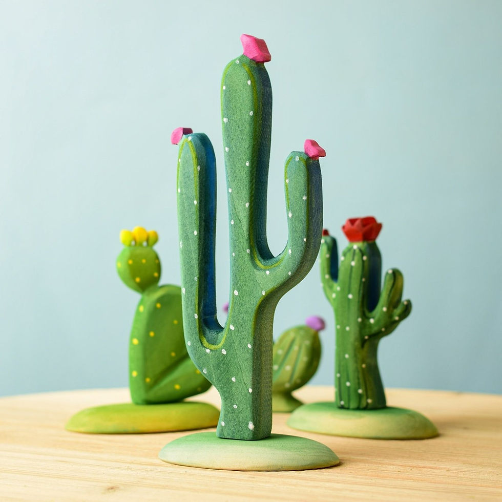 Wooden Mexican cactus with other wooden cacti on a wooden surface by Bumbu Toys
