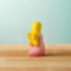 Back view of the Bumbu Toys pink fairy showing small yellow butterfly-style wings.