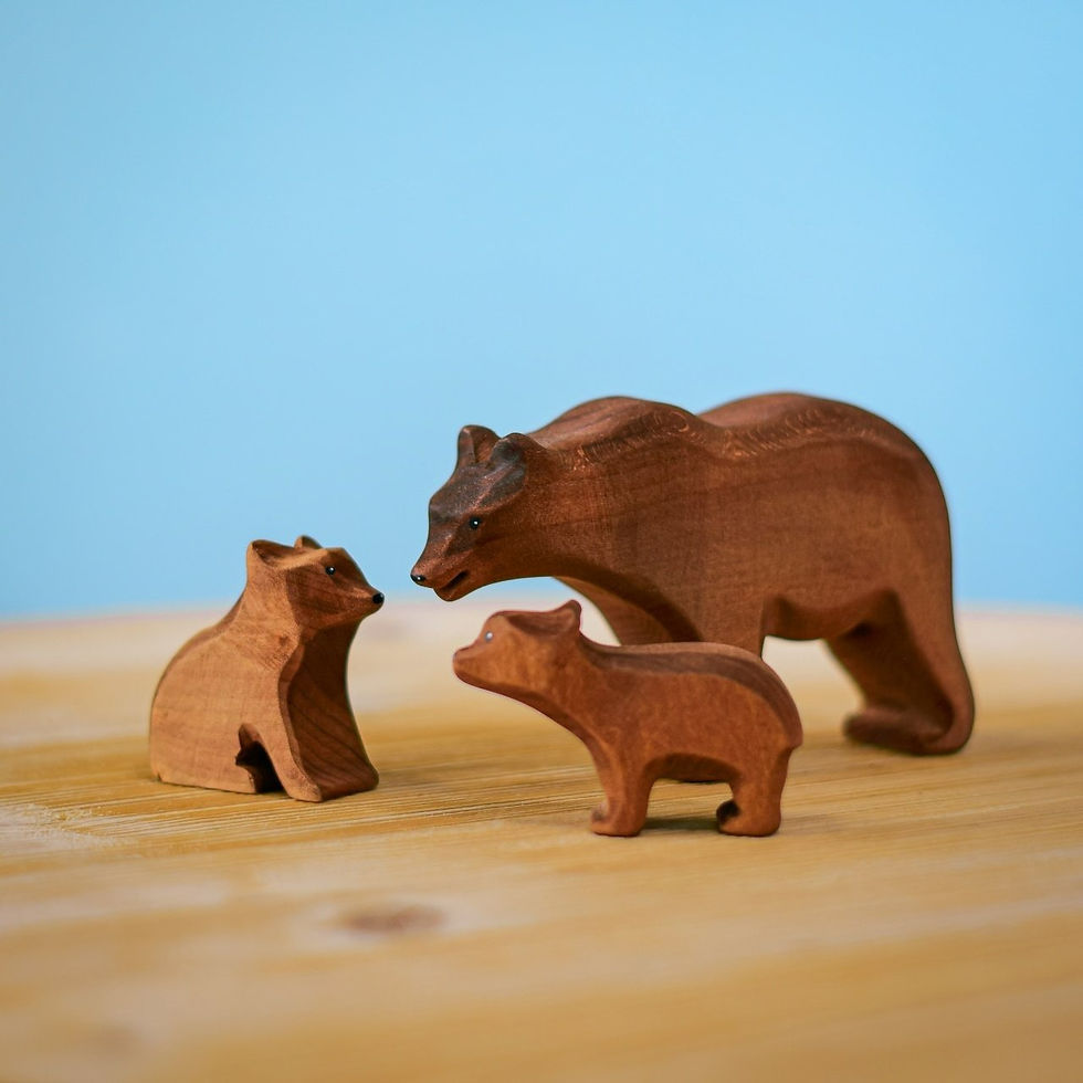 Handcrafted wooden bear family on a wooden surface