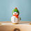 Thumbnail: Bumbu Toys Wooden Snowman Birthday Ring Ornament on wooden celebration ring, wearing a green hat and orange scarf.