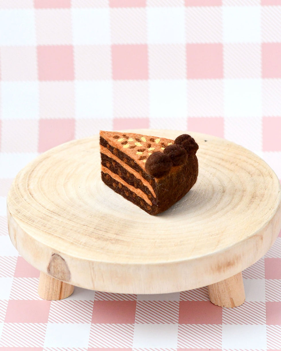 Thumbnail: Tara Treasures Felt German Chocolate Cake Slice on a Rustic Wooden Stand
