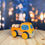 Thumbnail: Hand-painted DADU Wooden Pickup Truck in orange with blue and white dot-style spring blossom design made from natural wood