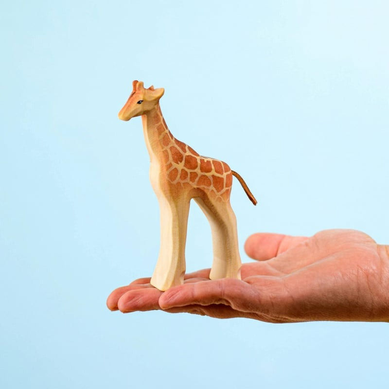 Thumbnail: Hand holding the adorable organic wooden giraffe calf toy by Bumbu Toys