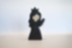 wooden black princess figurine by Juharka, featuring a dark gown, a crown, and a small black bird on her hand, made of wood.