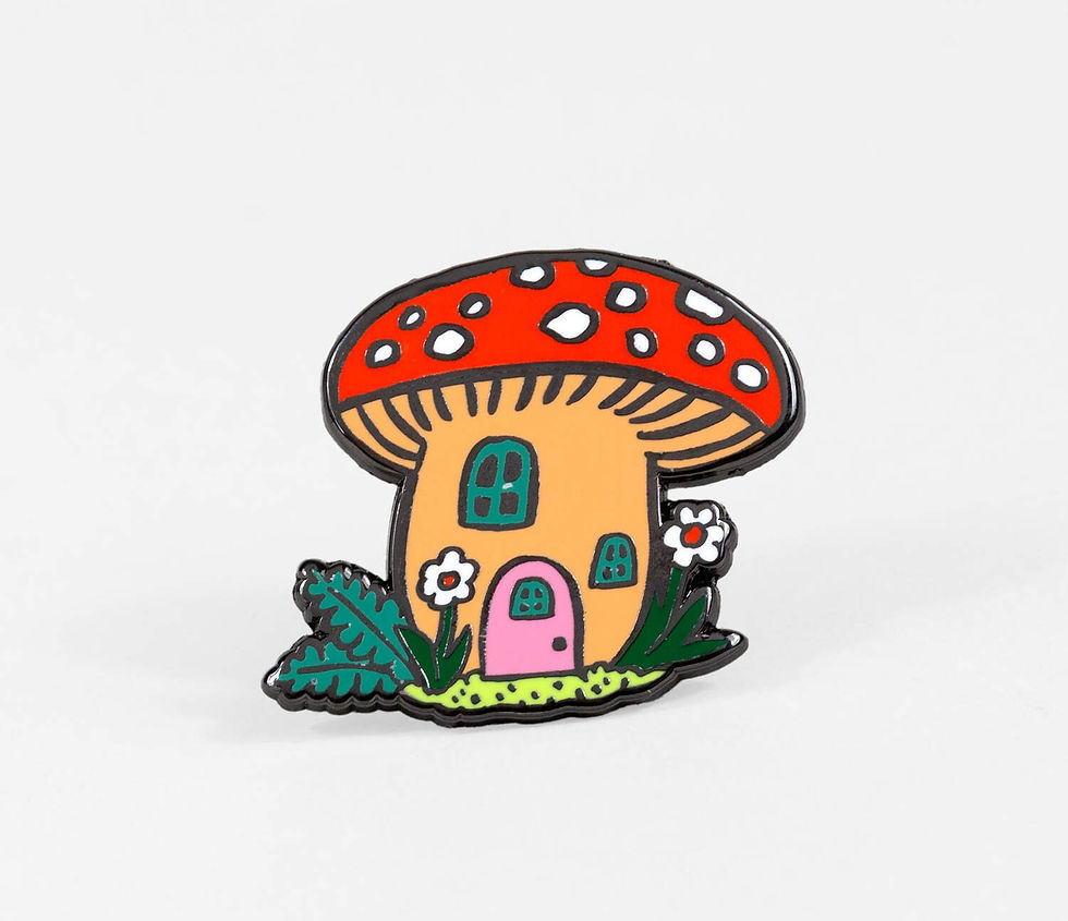 Mushroom Cottage enamel pin by Phoebe Wahl featuring a red toadstool house with pink door and flowers