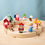Thumbnail: Bumbu Toys Wooden Candy Cane displayed among other Bumbu festive birthday ring ornaments, Santa, Tree, and Gingerbread Man.